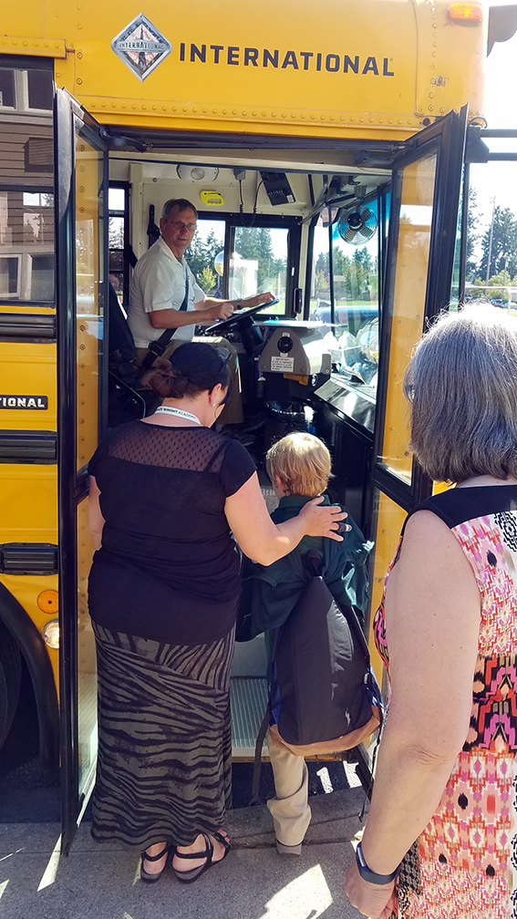 student boards a charles wright academy bus